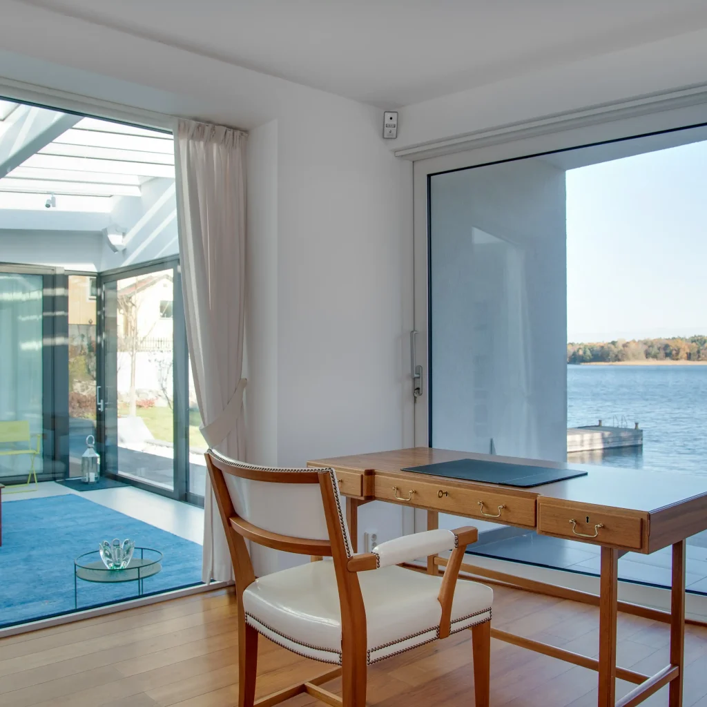 Luxury beach house with large glass windows overlooking the ocean